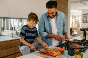 a father and son preparing a healthy meal