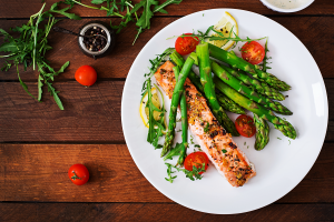 a healthy plated meal of fish and vibrant veggies.
